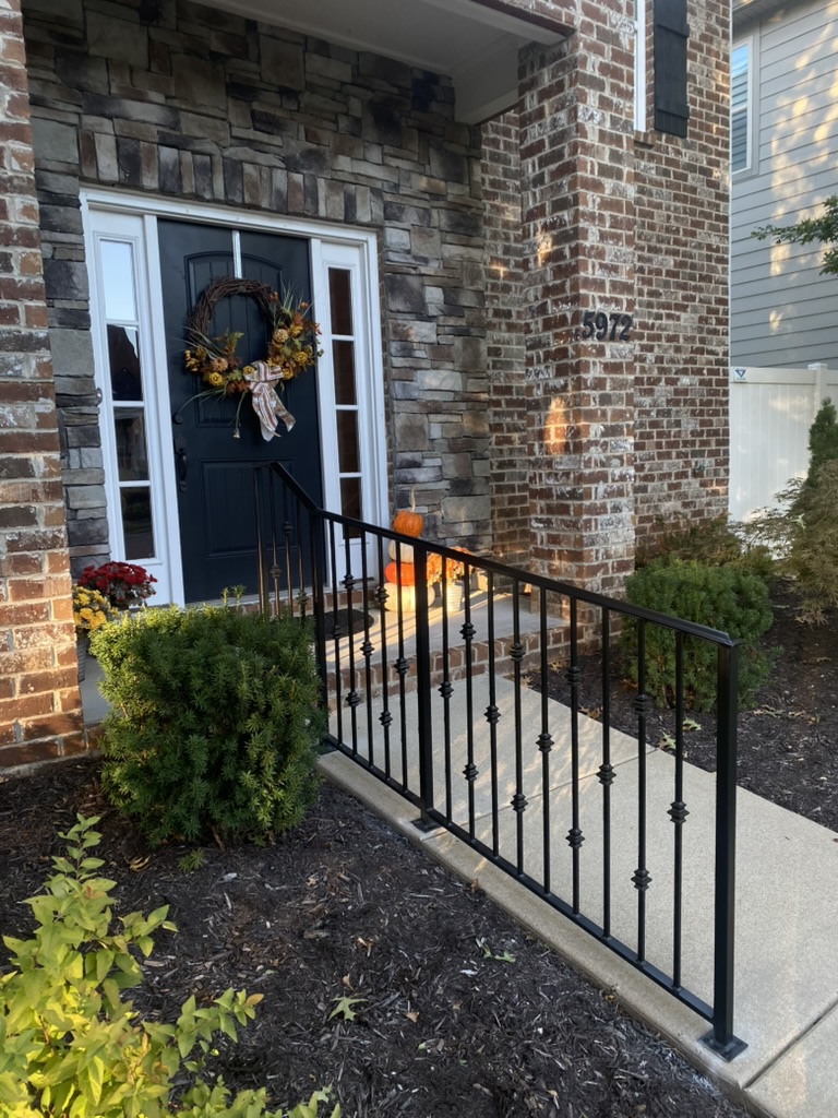 black metal fence in nashville leading up to front door